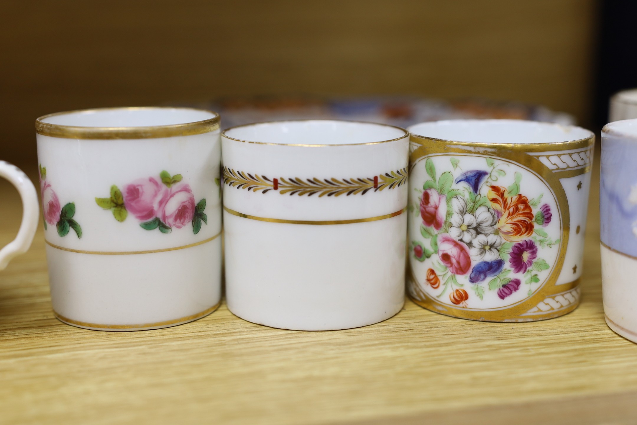 Seven early 19th century coffee cans and three Ridgway Imari style plates, plates 23 cms diameter